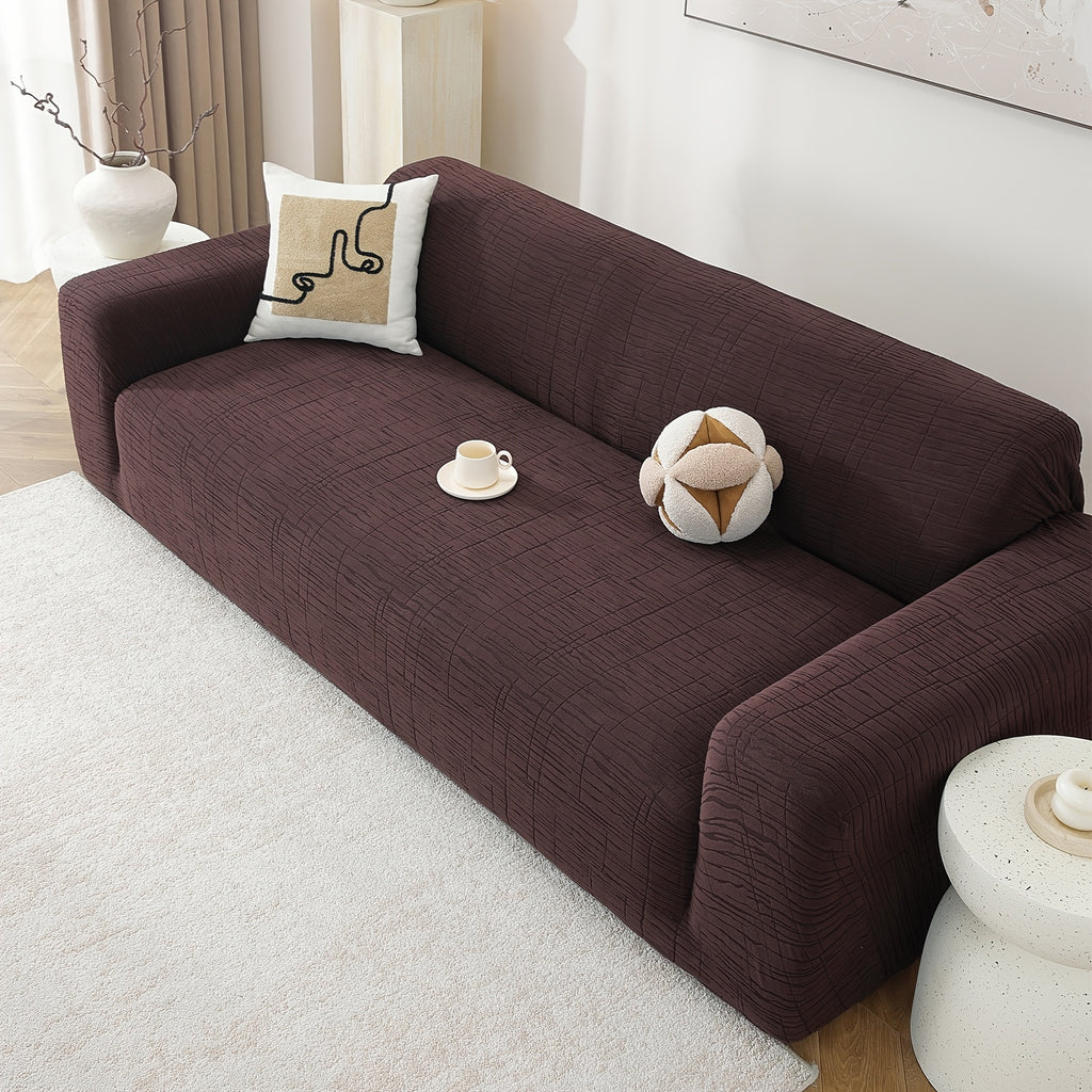 Housse de canapé extensible en polaire jacquard à motif géométrique, détail de l'ourlet