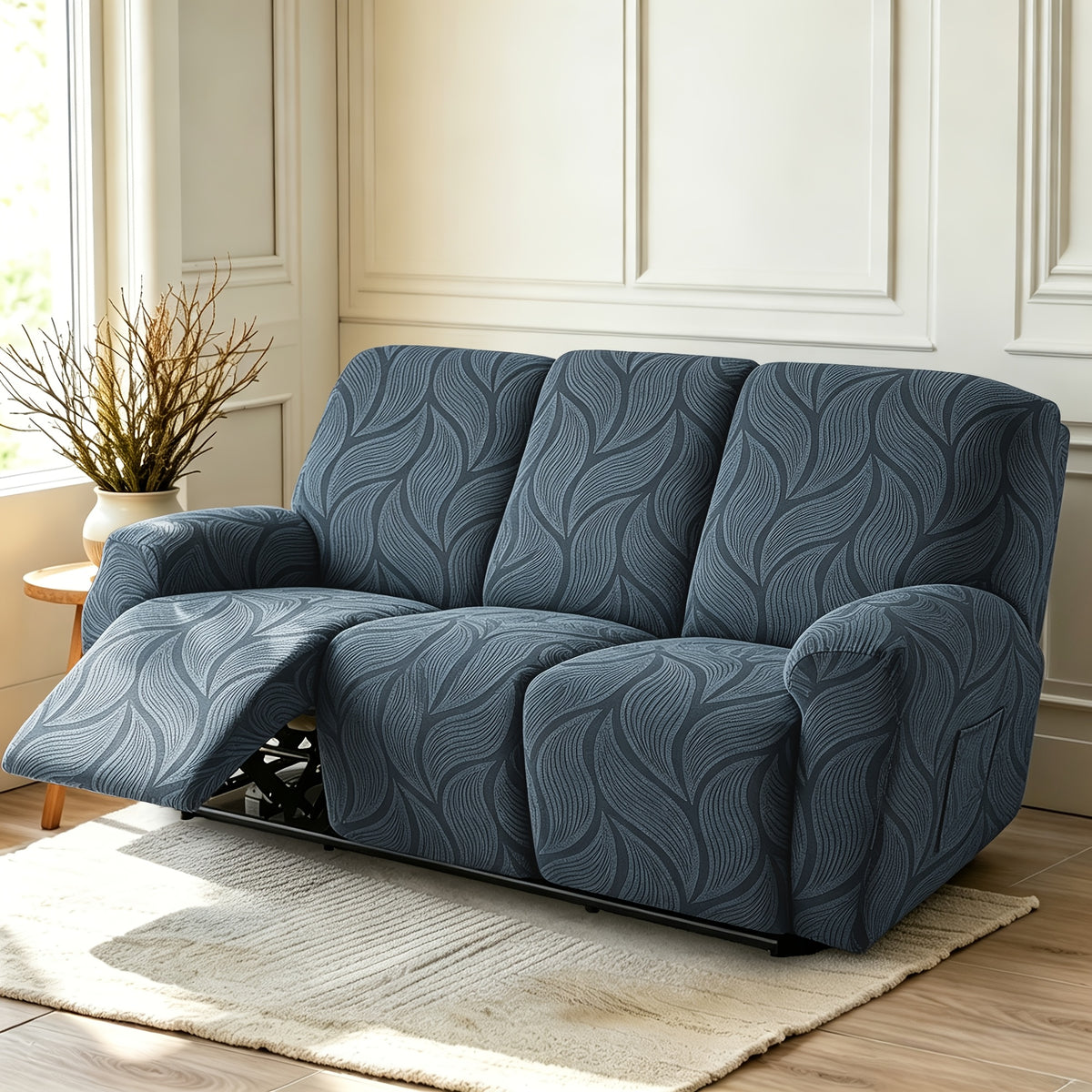 Housse de canapé extensible en polaire jacquard à motif feuillage, détail de l'ourlet