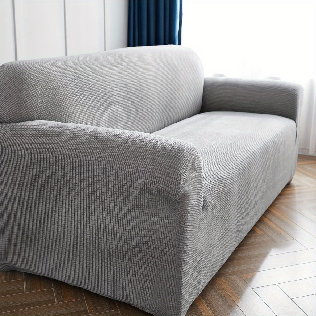 Housse de canapé extensible en polaire matelassée antidérapante, détail de l'ourlet