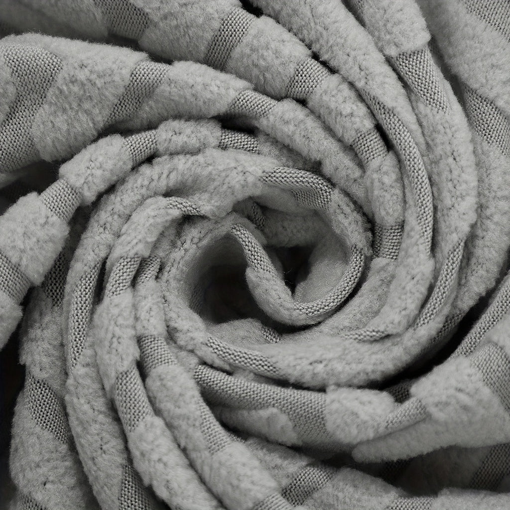 Housse de canapé extensible en polaire jacquard, détail de l'ourlet