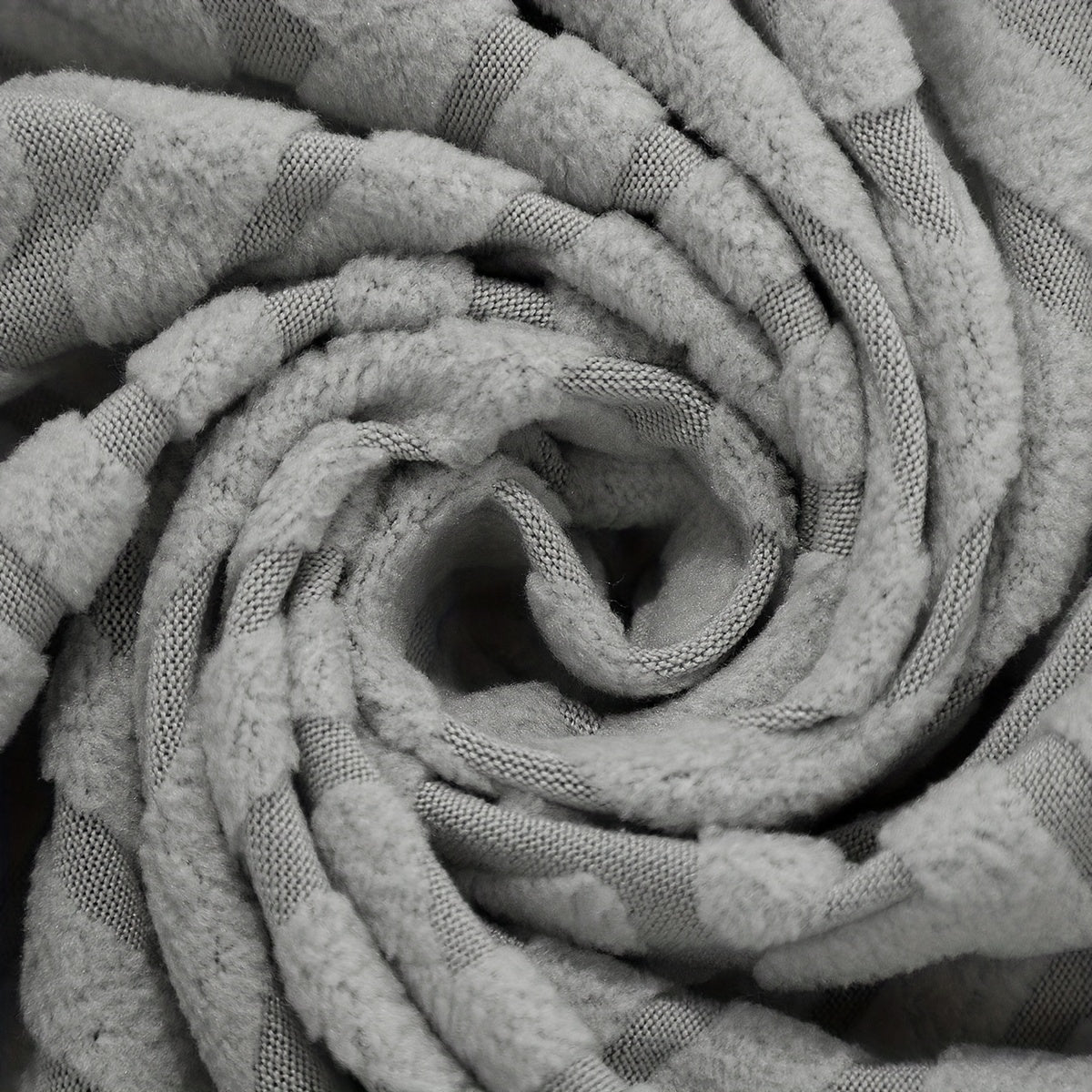 Housse de canapé extensible en polaire jacquard, détail de l'ourlet