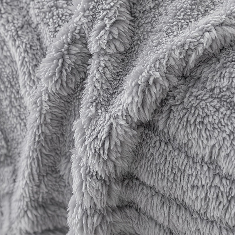Housse de canapé en peluche à motif feuillage antidérapante, détail de l'ourlet