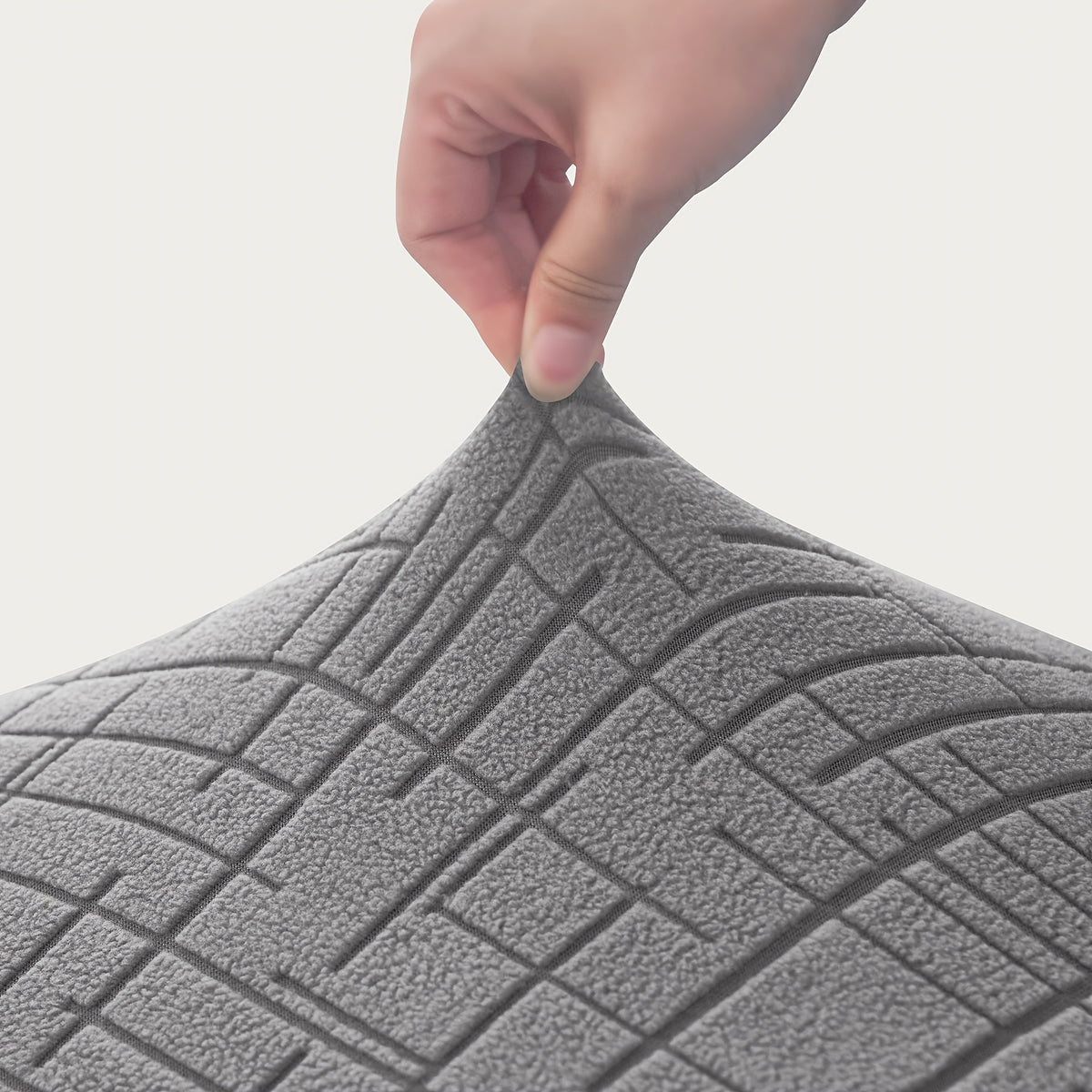 Housse de canapé extensible en polyester, détail de la finition