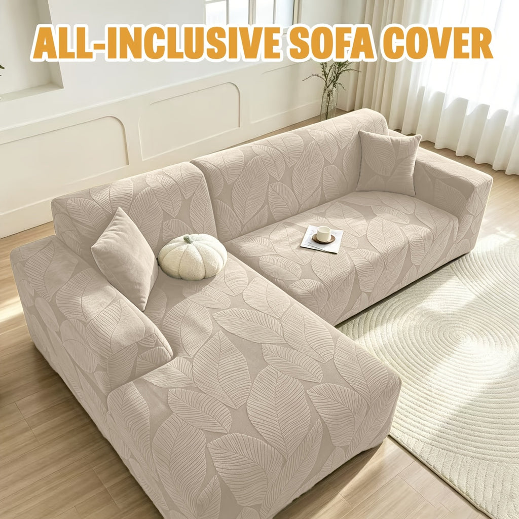Housse de canapé extensible en polaire jacquard à motif feuillage au rendu, détail de l'ourlet