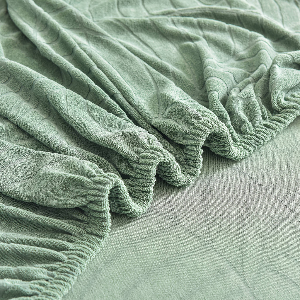 Housse de canapé extensible en polaire jacquard à motif feuillage à housses, détail de la finition