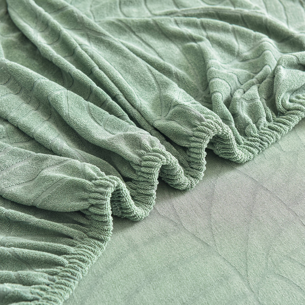 Housse de canapé extensible en polaire jacquard à motif feuillage à housses, détail de la finition